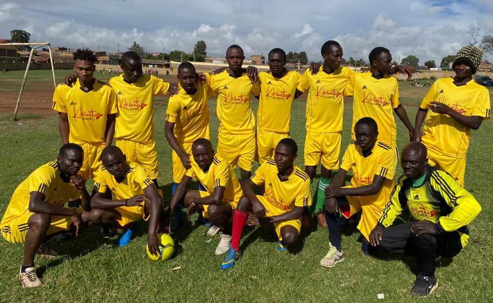 a group of men in yellow uniforms posing for a picture